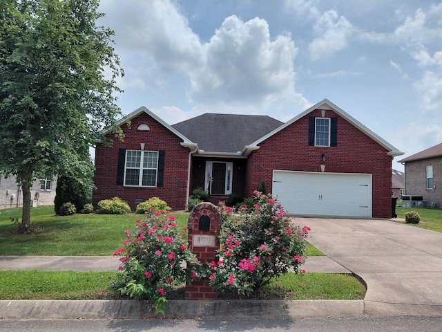 179 Avalon Dr, Gallatin, TN 37066 - view of front of property with brick siding, a front yard, driveway, and a garage