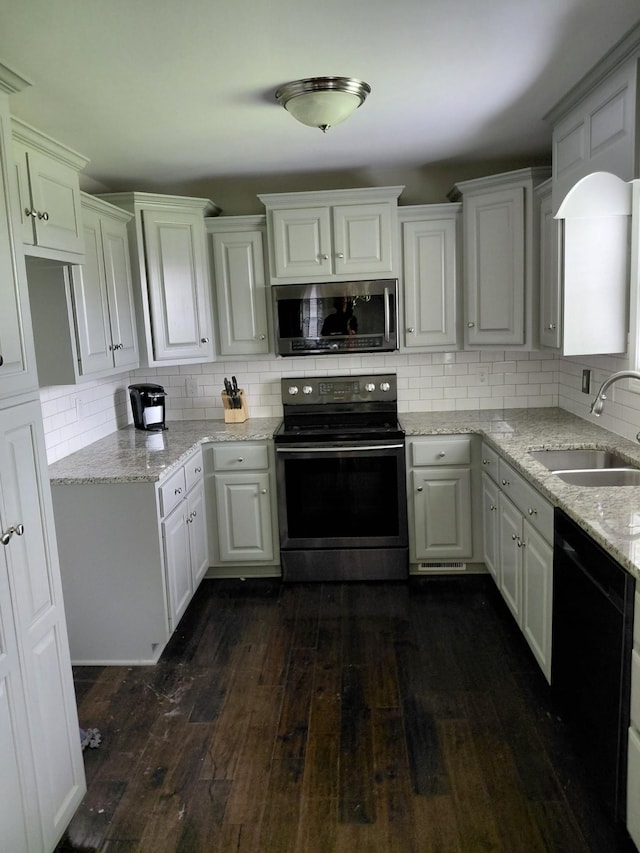 179 Avalon Dr, Gallatin, TN 37066 - kitchen featuring stainless steel appliances, dark wood-type flooring, backsplash, light stone countertops, and white cabinets