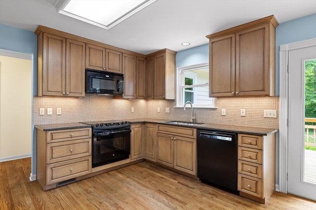 3604 Gentry Station Dr, Signal Mountain, TN 37377 - kitchen with black appliances, light wood-style flooring, tasteful backsplash, dark stone countertops, and recessed lighting