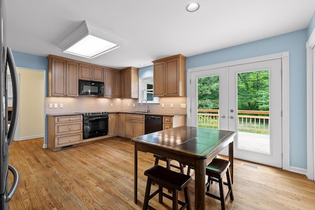 3604 Gentry Station Dr, Signal Mountain, TN 37377 - kitchen with black appliances, french doors, decorative backsplash, light wood-style flooring, and recessed lighting