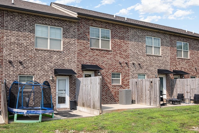 121 Bellvue Dr, Lebanon, TN 37090 - rear view of house featuring brick siding, a patio, and an outdoor fire pit
