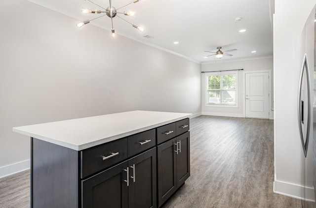 121 Bellvue Dr, Lebanon, TN 37090 - kitchen with crown molding, light wood-style flooring, a kitchen island, light countertops, and ceiling fan