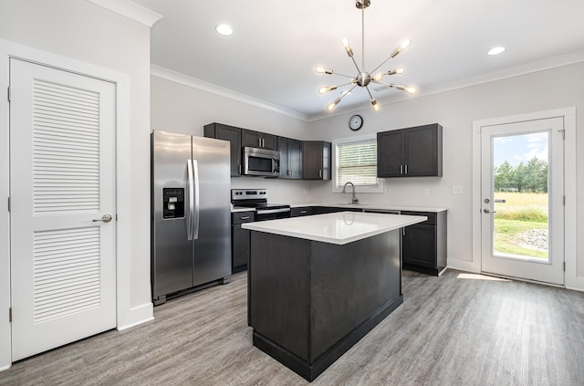 121 Bellvue Dr, Lebanon, TN 37090 - kitchen featuring stainless steel appliances, crown molding, a chandelier, light wood-type flooring, and light countertops
