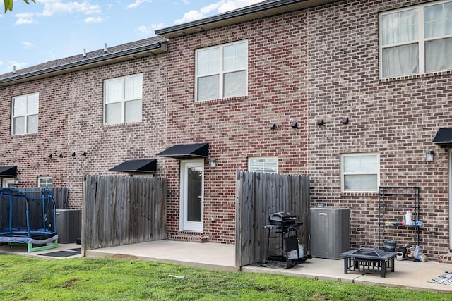 121 Bellvue Dr, Lebanon, TN 37090 - back of house with a patio area, brick siding, and a trampoline