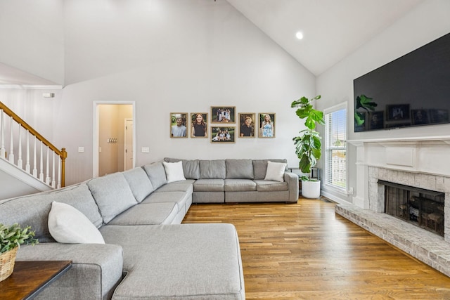 1005 Rudder Dr, Spring Hill, TN 37174 - living room featuring high vaulted ceiling, a fireplace, light wood-style flooring, stairs, and recessed lighting