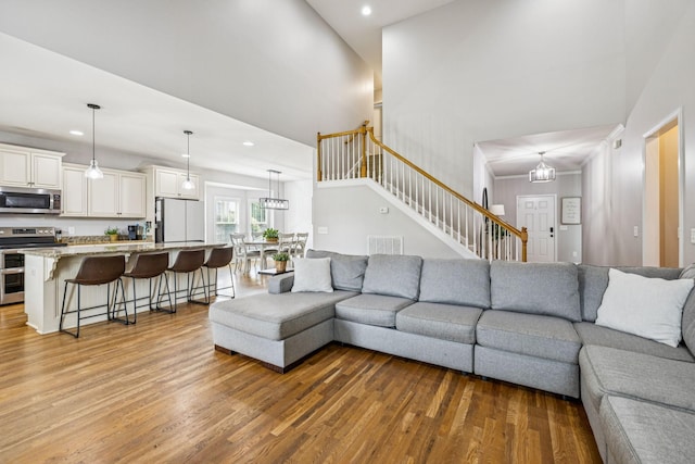 1005 Rudder Dr, Spring Hill, TN 37174 - living room with wood finished floors, recessed lighting, stairway, and a high ceiling
