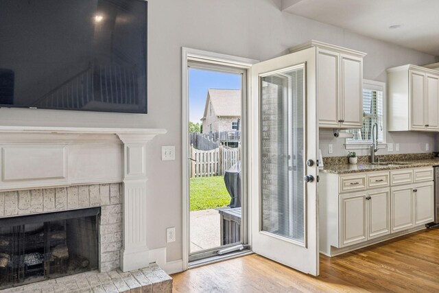 1005 Rudder Dr, Spring Hill, TN 37174 - entryway featuring light wood finished floors and a brick fireplace