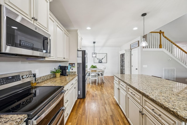 1005 Rudder Dr, Spring Hill, TN 37174 - kitchen featuring stainless steel appliances, light wood-style flooring, hanging light fixtures, light stone countertops, and recessed lighting