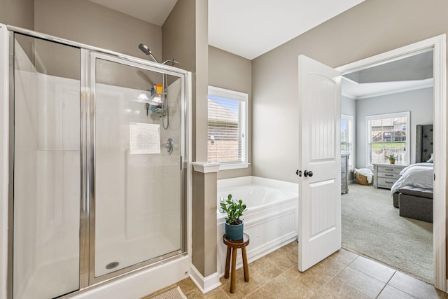 1005 Rudder Dr, Spring Hill, TN 37174 - bathroom featuring connected bathroom, a shower stall, a garden tub, and plenty of natural light