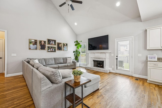 1005 Rudder Dr, Spring Hill, TN 37174 - living area featuring high vaulted ceiling, ceiling fan, wood finished floors, recessed lighting, and a brick fireplace