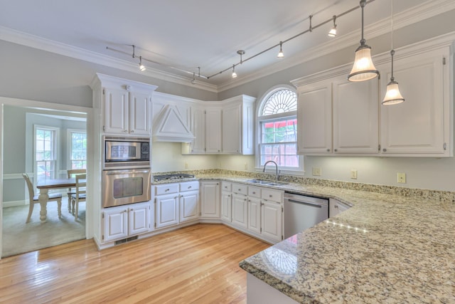 101 Spring Creek Trl, Hendersonville, TN 37075 - kitchen featuring appliances with stainless steel finishes, track lighting, light stone countertops, white cabinetry, and ornamental molding
