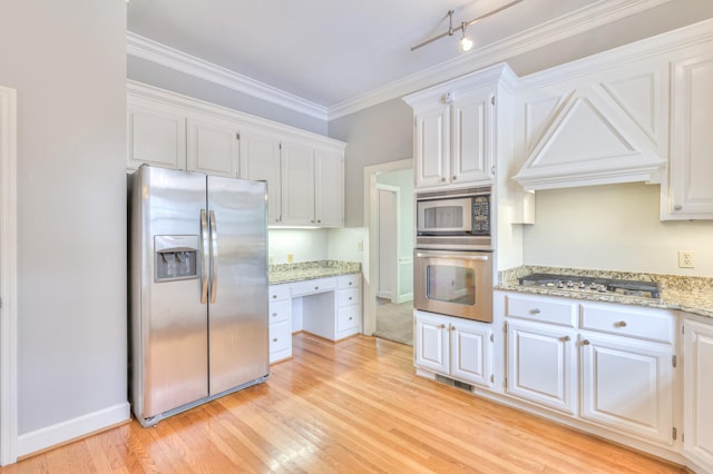 101 Spring Creek Trl, Hendersonville, TN 37075 - kitchen featuring stainless steel appliances, white cabinets, built in study area, light wood-style flooring, and light stone counters