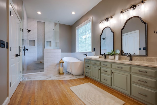 101 Oak Dr, Waverly, TN 37185 - full bath with walk in shower, double vanity, a freestanding tub, wood finished floors, and recessed lighting