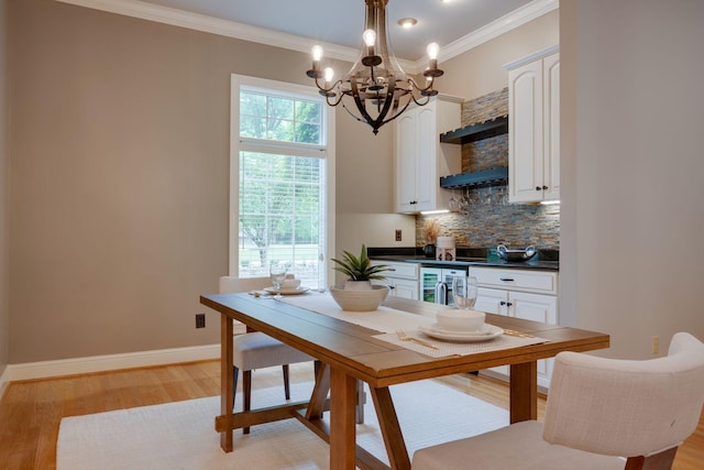 101 Oak Dr, Waverly, TN 37185 - dining area featuring a chandelier, light wood finished floors, crown molding, and wine cooler