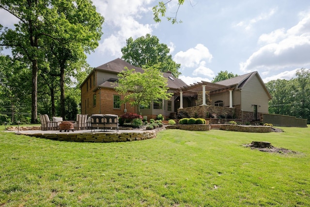 101 Oak Dr, Waverly, TN 37185 - back of property with a pergola, a lawn, a patio, brick siding, and a fire pit