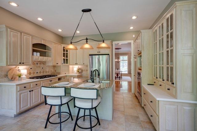 101 Oak Dr, Waverly, TN 37185 - kitchen with stainless steel appliances, an island with sink, backsplash, a breakfast bar, and recessed lighting
