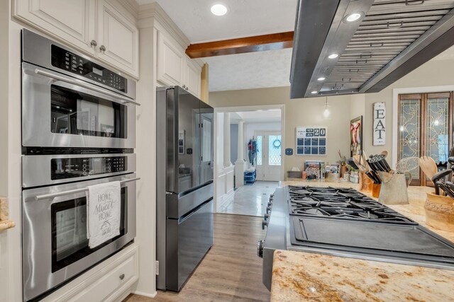 2600 Clanton Rd, Lawrenceburg, TN 38464 - kitchen with range hood, appliances with stainless steel finishes, white cabinetry, light wood-style floors, and beamed ceiling