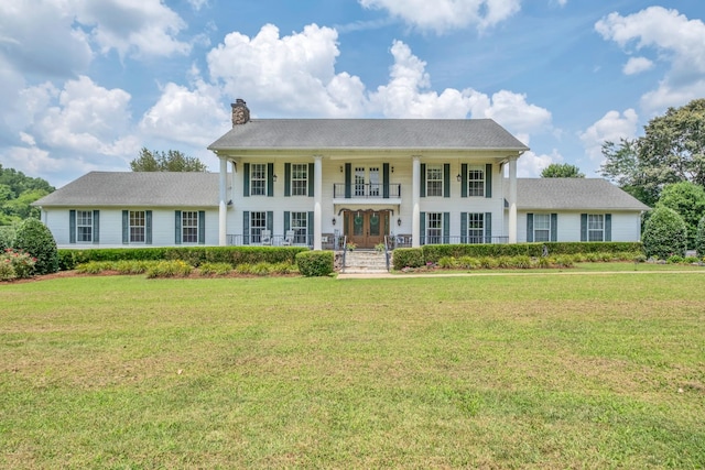 2600 Clanton Rd, Lawrenceburg, TN 38464 - view of front facade with french doors, a chimney, covered porch, and a front lawn