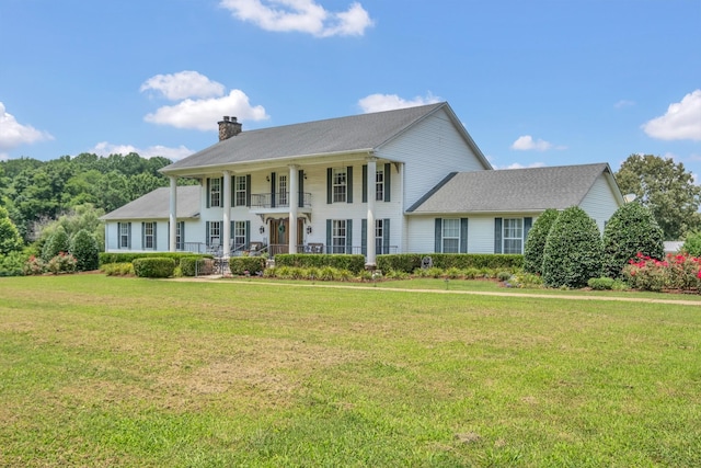 2600 Clanton Rd, Lawrenceburg, TN 38464 - view of front facade featuring a chimney, covered porch, a front yard, and a balcony