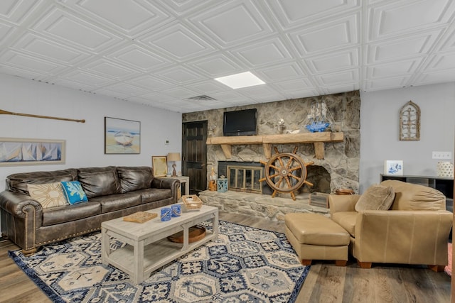2600 Clanton Rd, Lawrenceburg, TN 38464 - living area featuring a fireplace, wood finished floors, and an ornate ceiling