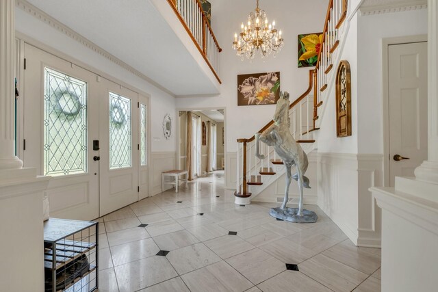 2600 Clanton Rd, Lawrenceburg, TN 38464 - foyer entrance featuring stairs, a decorative wall, wainscoting, light tile patterned floors, and a chandelier