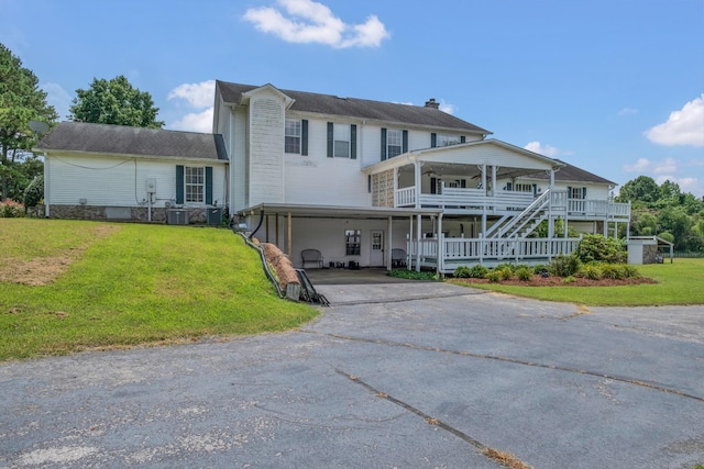 2600 Clanton Rd, Lawrenceburg, TN 38464 - view of front of house featuring asphalt driveway, a front yard, a porch, a carport, and a chimney