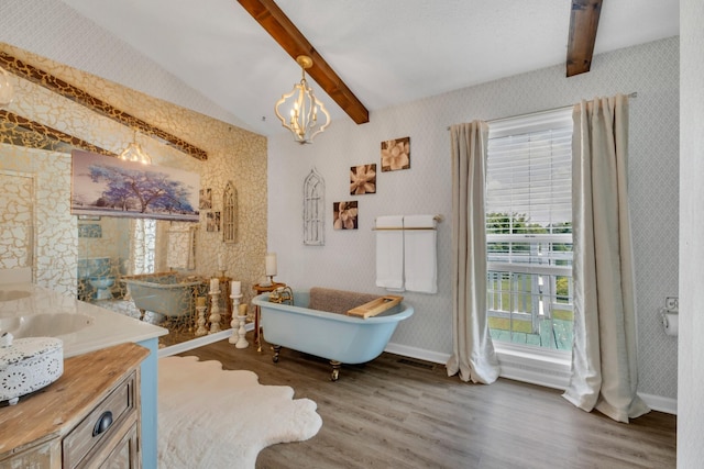 2600 Clanton Rd, Lawrenceburg, TN 38464 - bathroom with wallpapered walls, wood finished floors, vanity, a freestanding tub, and a chandelier