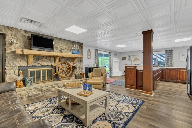 2600 Clanton Rd, Lawrenceburg, TN 38464 - living area with a fireplace, light wood-style flooring, an ornate ceiling, and decorative columns