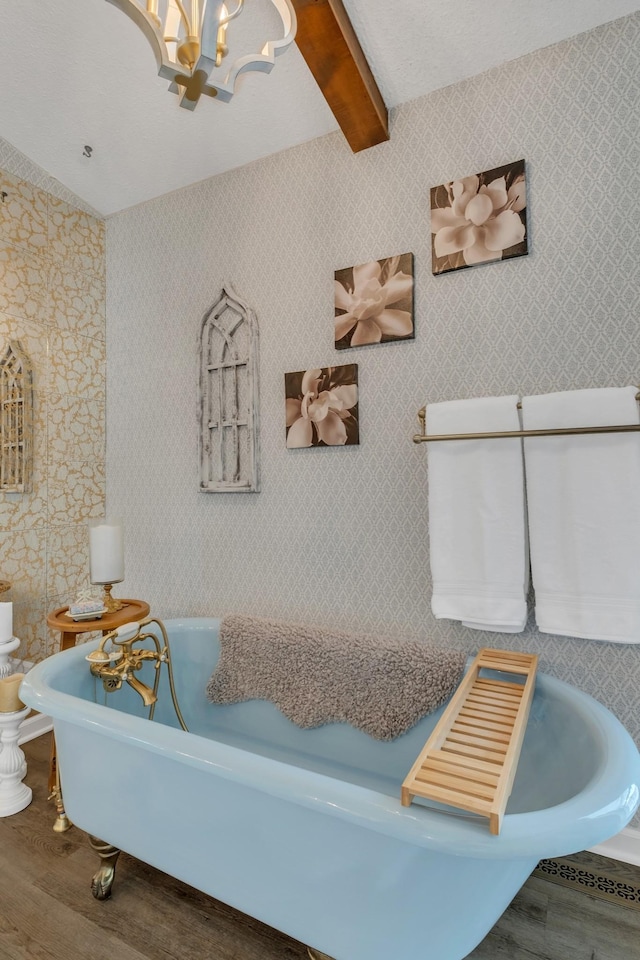 2600 Clanton Rd, Lawrenceburg, TN 38464 - full bathroom featuring wood finished floors, a freestanding bath, a chandelier, and beamed ceiling