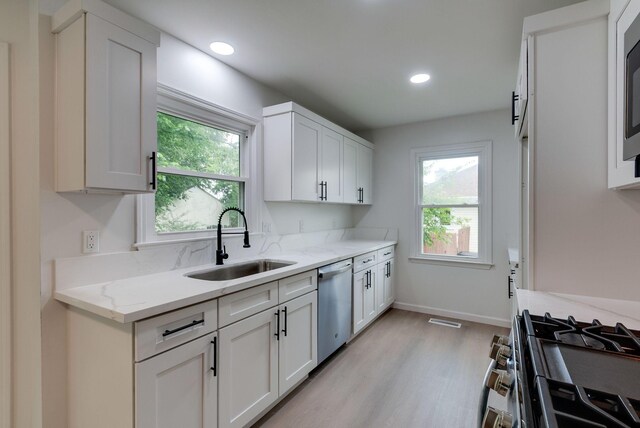 1602 Annie Ln, Columbia, TN 38401 - kitchen with stainless steel appliances, light wood-style floors, white cabinetry, light stone countertops, and recessed lighting