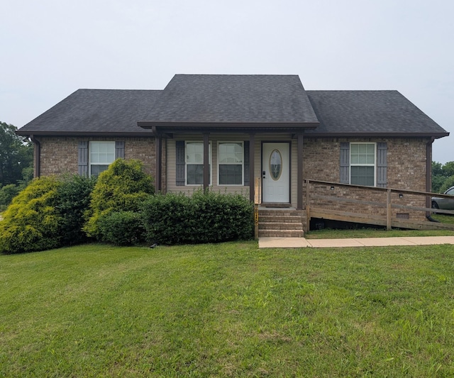 819 White Rd, Portland, TN 37148 - view of front of home featuring a front lawn, brick siding, and roof with shingles