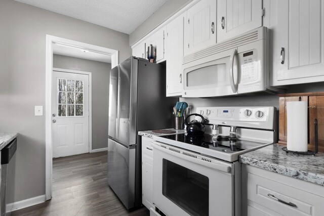 739 Carmack Ct, Clarksville, TN 37042 - kitchen with white appliances, dark wood-type flooring, white cabinets, light stone countertops, and a textured ceiling