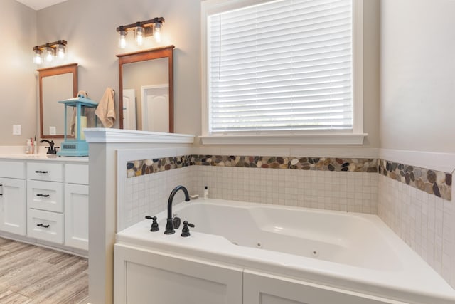 3215 Church St, Burns, TN 37029 - bathroom featuring vanity, a tub with jets, and wood finished floors