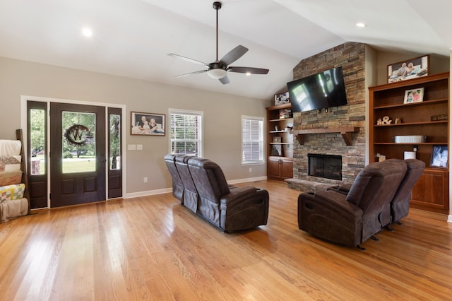 3215 Church St, Burns, TN 37029 - living area featuring vaulted ceiling, ceiling fan, light wood-style floors, and a stone fireplace