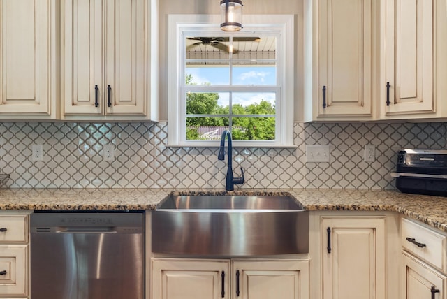 3215 Church St, Burns, TN 37029 - kitchen with stainless steel dishwasher, cream cabinetry, decorative backsplash, and light stone countertops