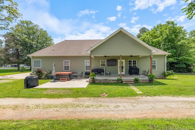 3215 Church St, Burns, TN 37029 - rear view of house with a hot tub, ceiling fan, a patio area, a lawn, and a shingled roof