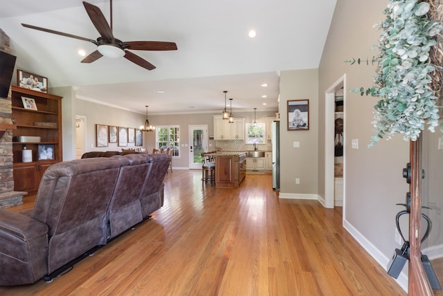 3215 Church St, Burns, TN 37029 - living room featuring a ceiling fan, light wood finished floors, a chandelier, recessed lighting, and crown molding