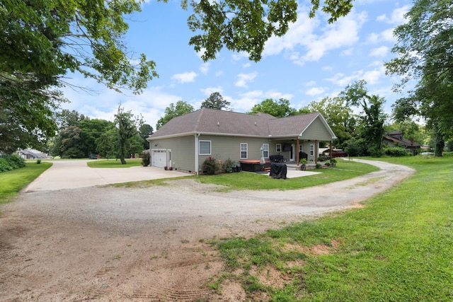 3215 Church St, Burns, TN 37029 - view of side of home featuring concrete driveway, an attached garage, and a yard