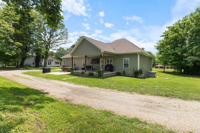 3215 Church St, Burns, TN 37029 - view of front of house with a front yard, a patio area, ceiling fan, dirt driveway, and a shingled roof