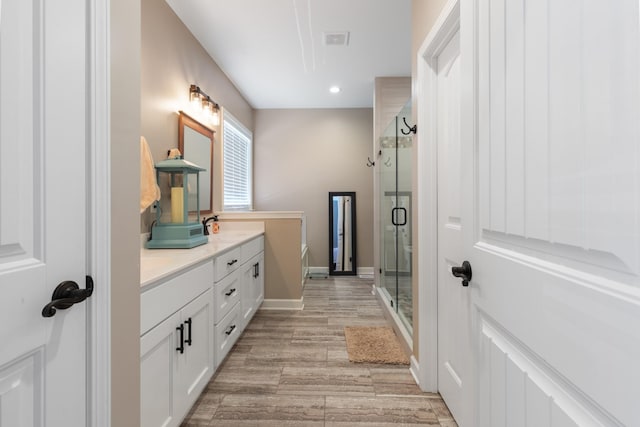 3215 Church St, Burns, TN 37029 - full bathroom with double vanity, a stall shower, recessed lighting, wood finished floors, and a tub to relax in