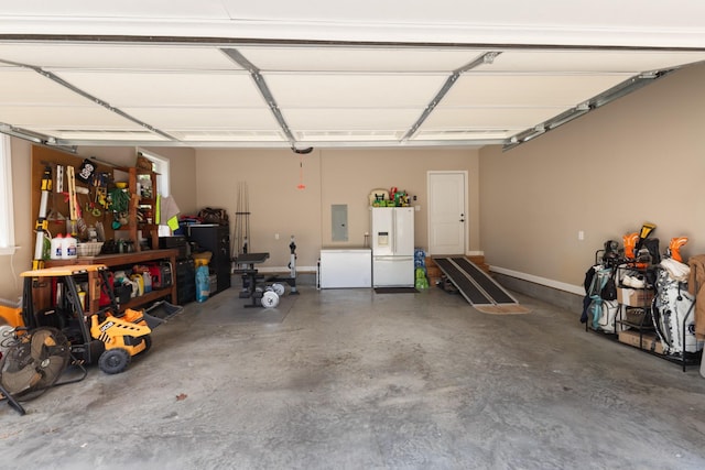 3215 Church St, Burns, TN 37029 - garage featuring white fridge with ice dispenser, electric panel, and fridge