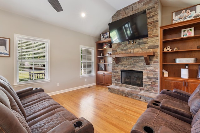 3215 Church St, Burns, TN 37029 - living area featuring lofted ceiling, a stone fireplace, light wood finished floors, ceiling fan, and built in features