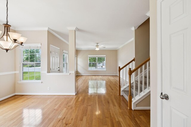 2025 Morrison Ave, Spring Hill, TN 37174 - unfurnished living room with light wood-style floors, stairway, ceiling fan, a chandelier, and ornamental molding