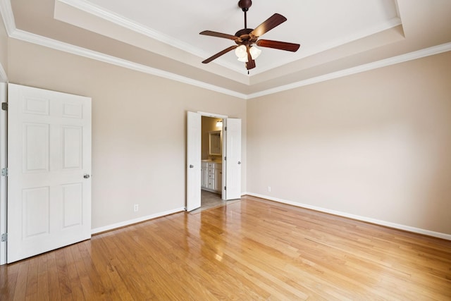 2025 Morrison Ave, Spring Hill, TN 37174 - unfurnished bedroom with a tray ceiling, light wood-style flooring, ornamental molding, a ceiling fan, and connected bathroom