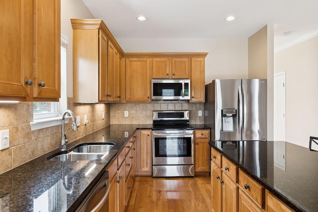 2025 Morrison Ave, Spring Hill, TN 37174 - kitchen with appliances with stainless steel finishes, light wood-type flooring, brown cabinets, crown molding, and tasteful backsplash