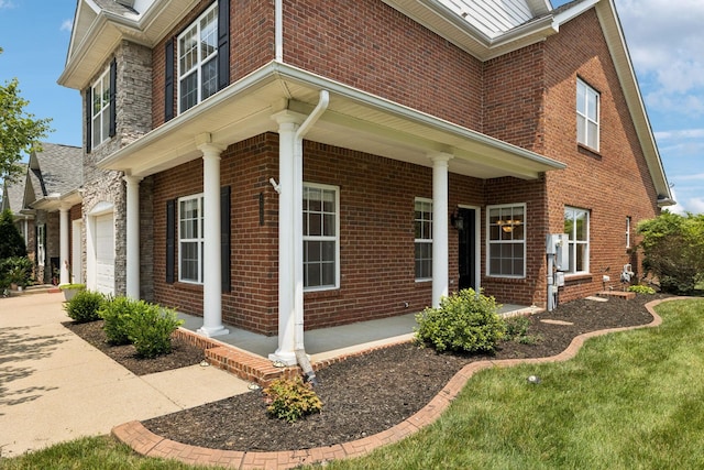 2025 Morrison Ave, Spring Hill, TN 37174 - view of property exterior with covered porch, brick siding, and an attached garage