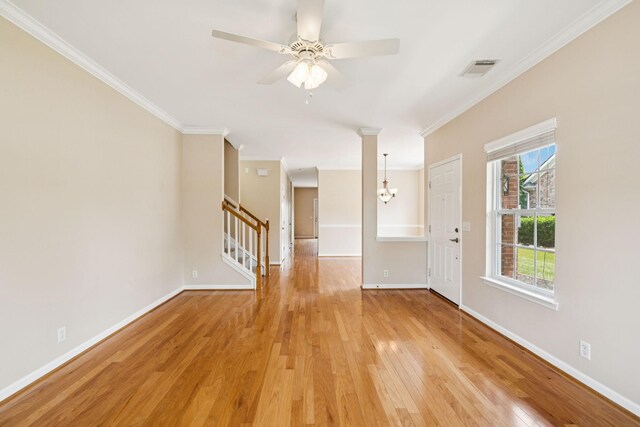 2025 Morrison Ave, Spring Hill, TN 37174 - empty room with crown molding, light wood-style flooring, ceiling fan, stairs, and a chandelier