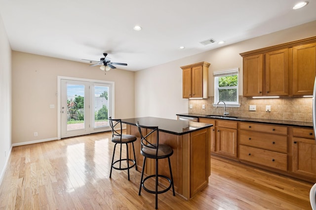 2025 Morrison Ave, Spring Hill, TN 37174 - kitchen featuring brown cabinets, dark countertops, ceiling fan, a breakfast bar, and recessed lighting