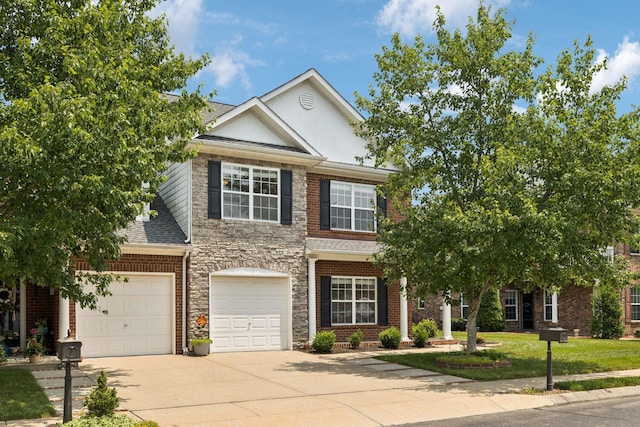 2025 Morrison Ave, Spring Hill, TN 37174 - view of front of property featuring concrete driveway, roof with shingles, stone siding, a front yard, and brick siding