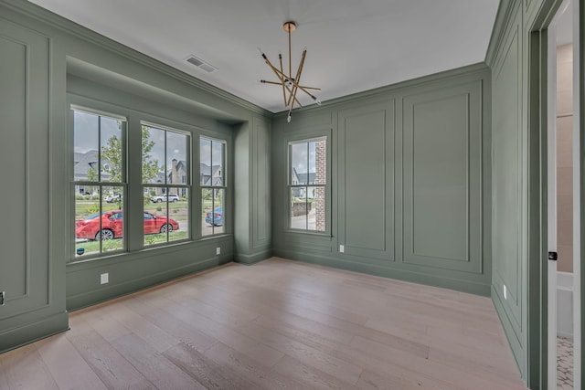 6060 Pasquo Rd, Nashville, TN 37221 - empty room with a decorative wall, a chandelier, light wood finished floors, and ornamental molding
